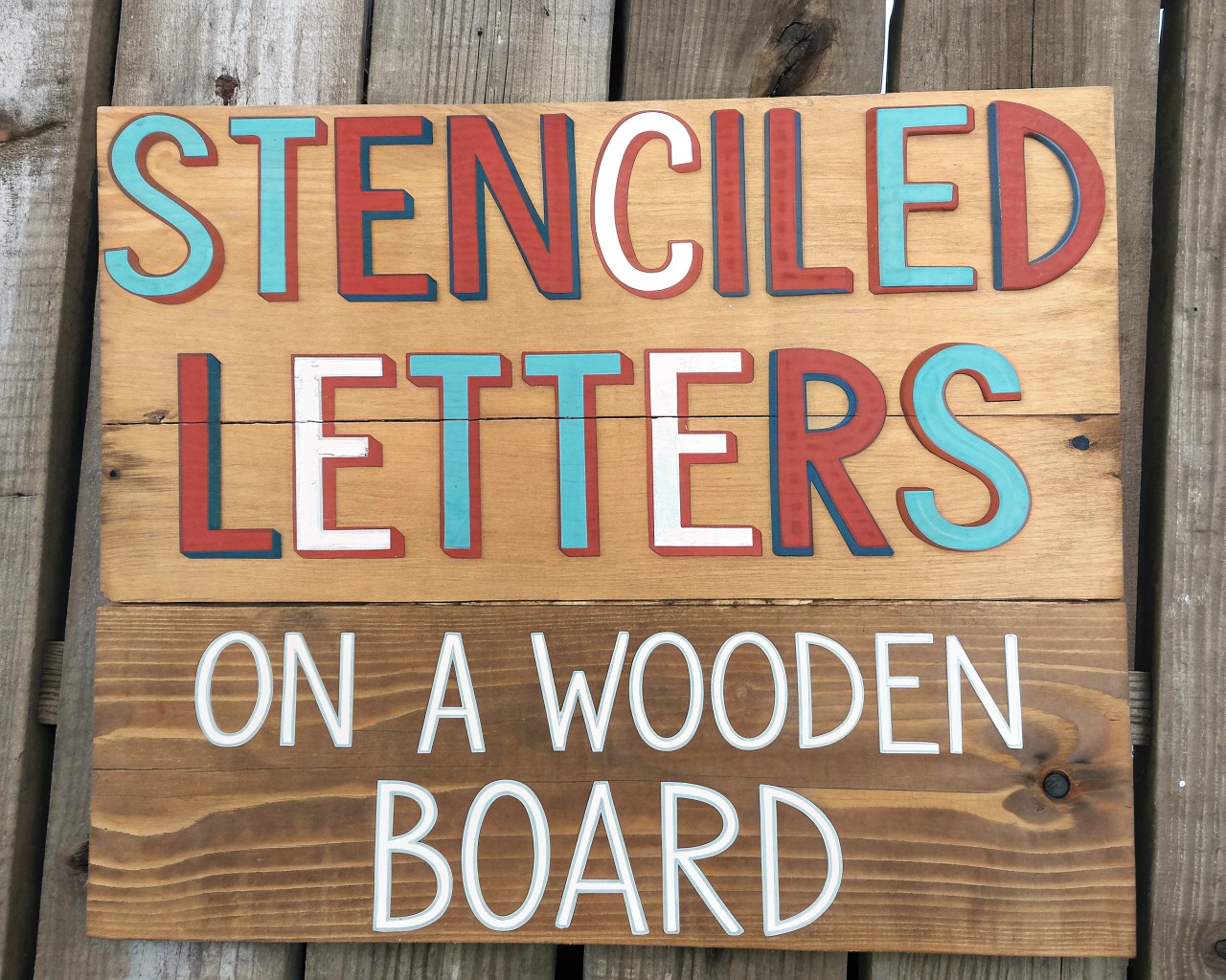 Detailing garden stakes with hand-lettered labels and symbolic icons for a personal touch